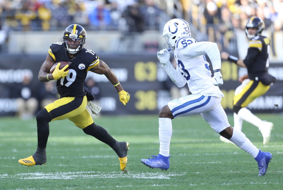 Pittsburgh Steelers wide receiver JuJu Smith-Schuster (19) tries to elude Indianapolis Colts linebacker Darius Leonard (53) in a 2019 game at Pittsburgh's Heinz Field.